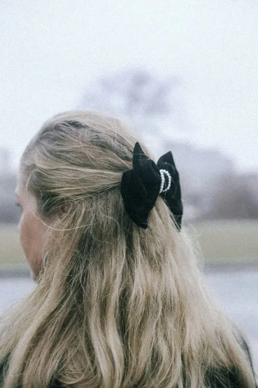 Black velvet bow on a half-up hairstyle