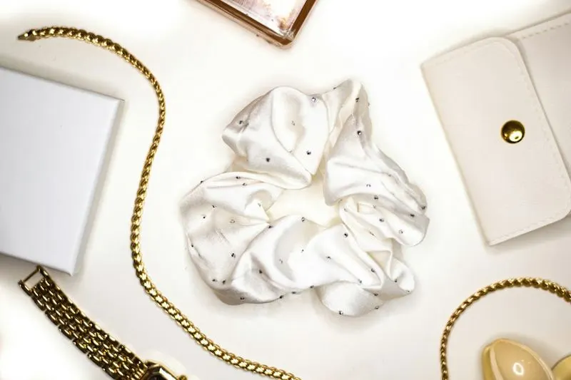 Ivory satin scrunchie styled with a cream purse