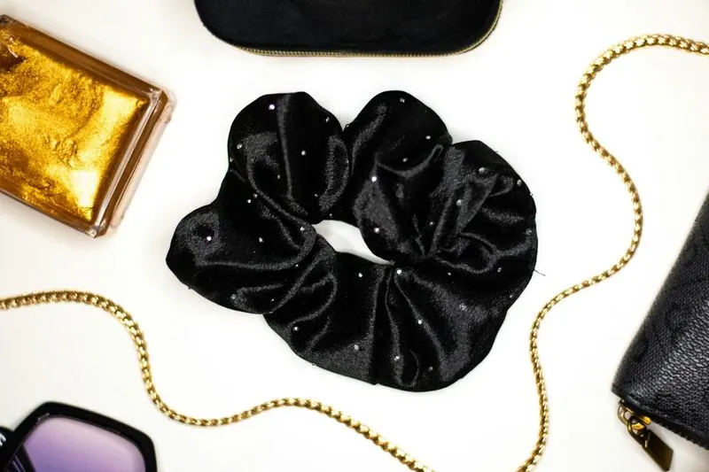 Black sparkle scrunchie with gold chain and perfume