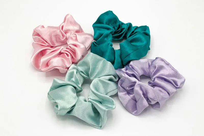 Four satin scrunchies in blush, teal, mint and lilac